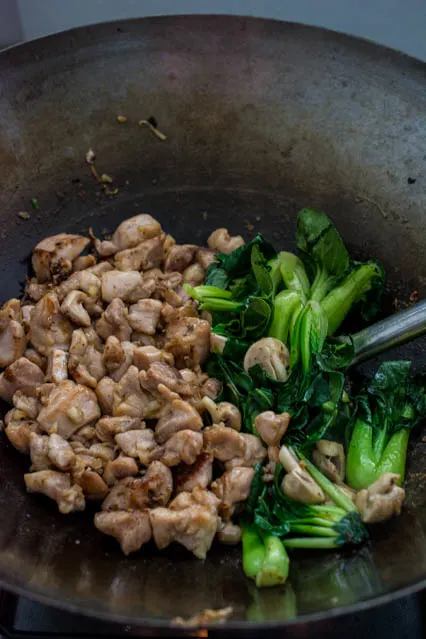 ginger sesame chicken with bok choy in wok