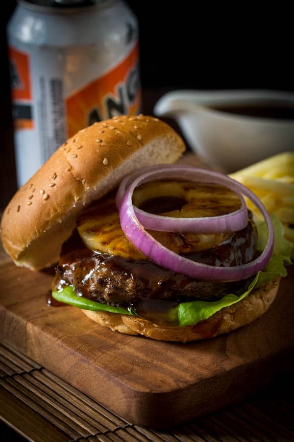 teriyaki burger with sliced red onion and pineapple