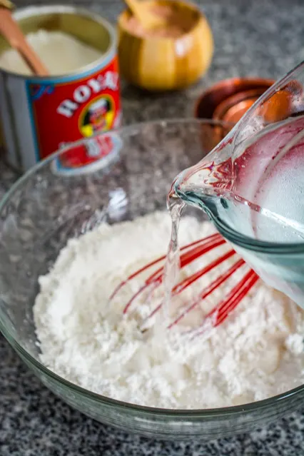 adding water to pisang goreng batter