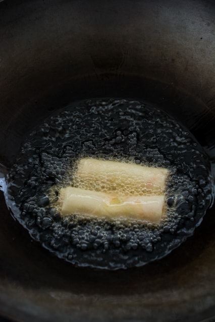 deep frying spring rolls in a wok