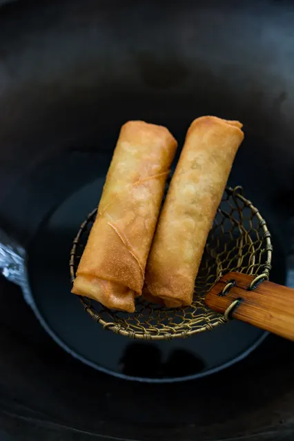 fried spring rolls on spider skimmer