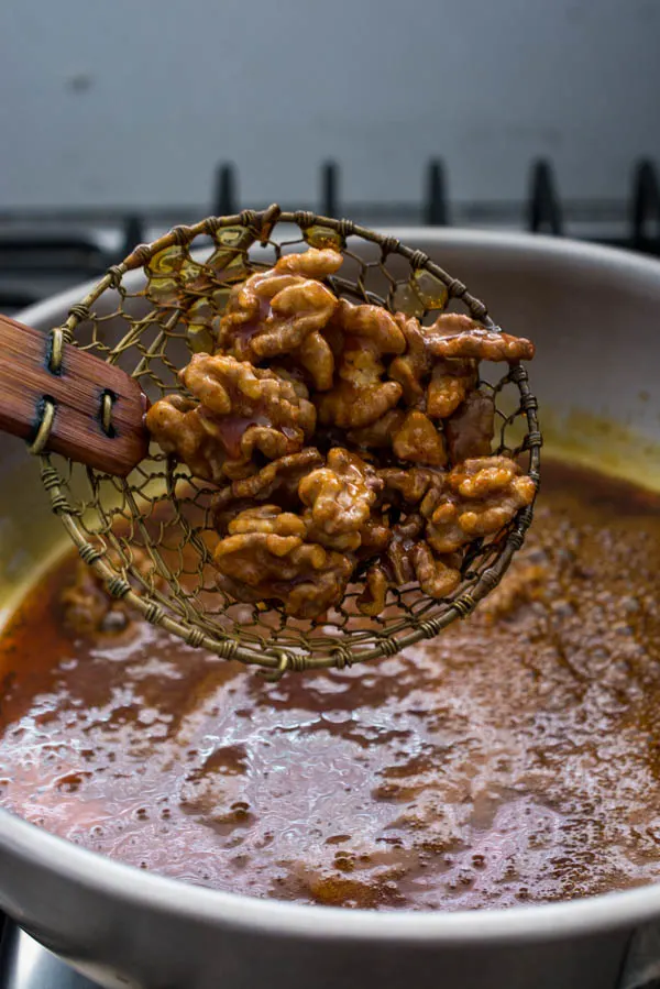 removing candied walnuts with spider skimmer