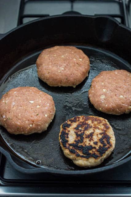 char siew burger patties in cast iron skillet