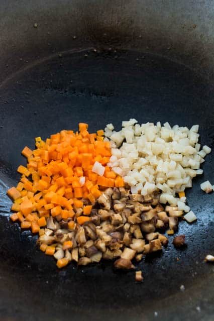 carrots, water chestnuts and shiitake mushrooms in wok