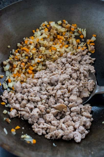 diced vegetables and ground pork in wok