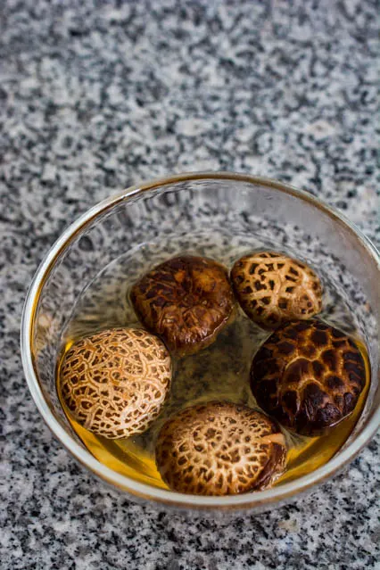 soaking dried shiitake mushrooms in warm water