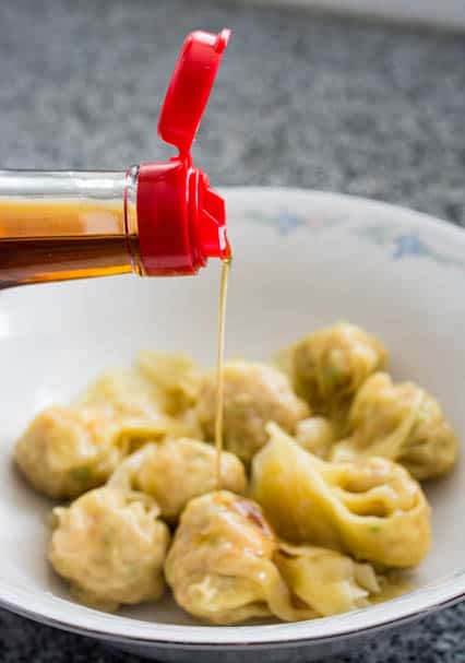 drizzling sesame oil over wontons