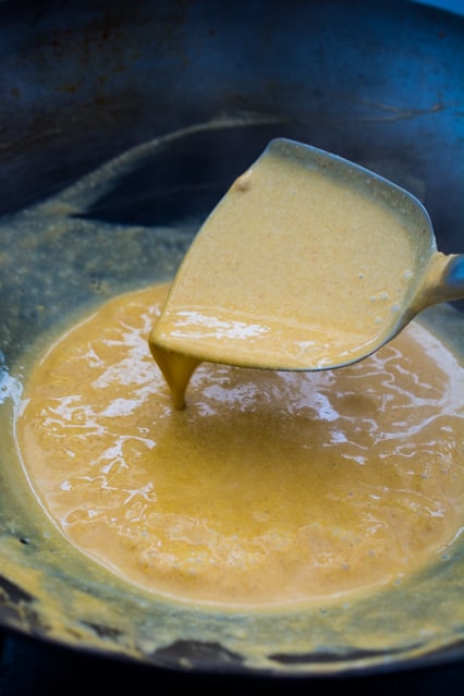 thai red curry simmering in a wok