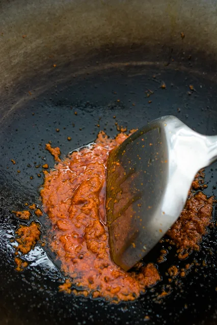 thai red curry with cooking oil in a wok