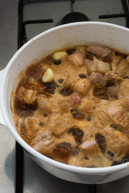 pork belly adobo simmering in pot