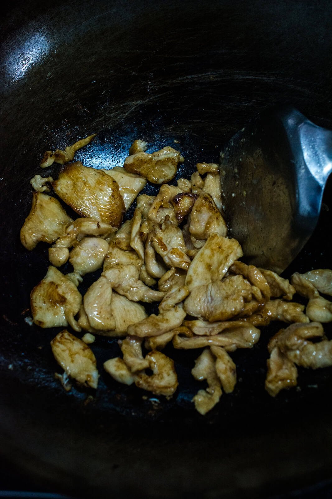 stir frying sliced chicken