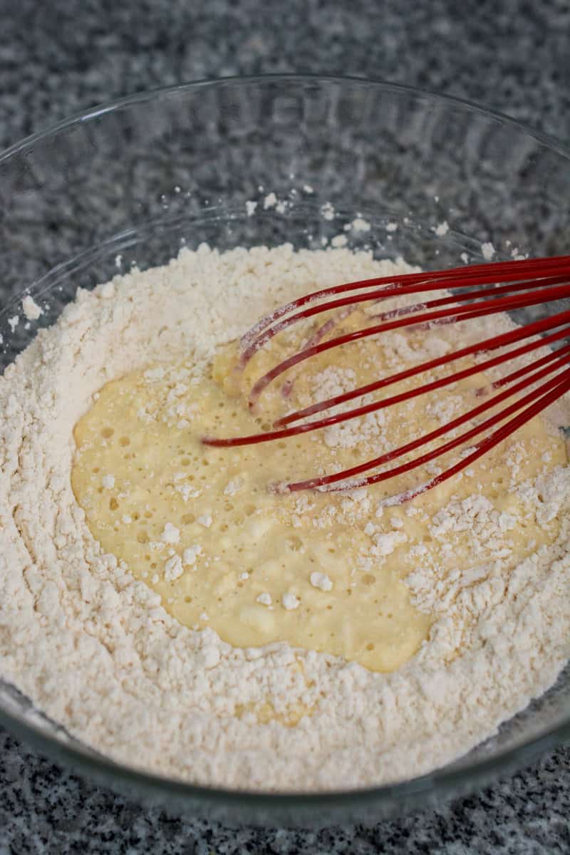 mixing the wet and dry ingredients for roti jala