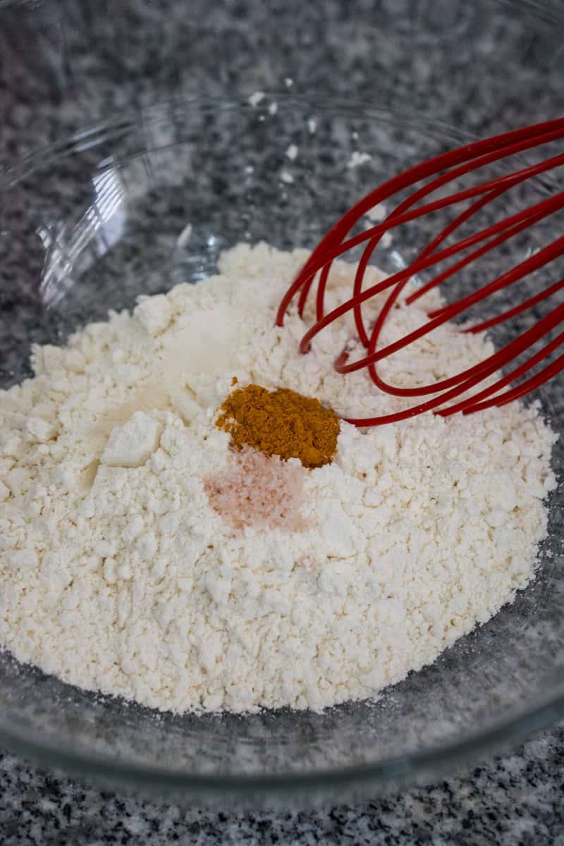 ground turmeric and salt in flour with a whisk