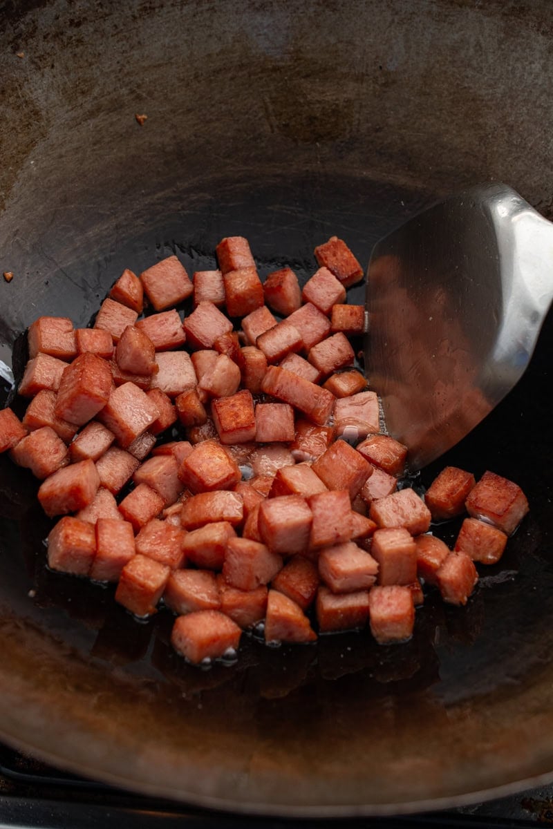 stir-frying spam in a wok