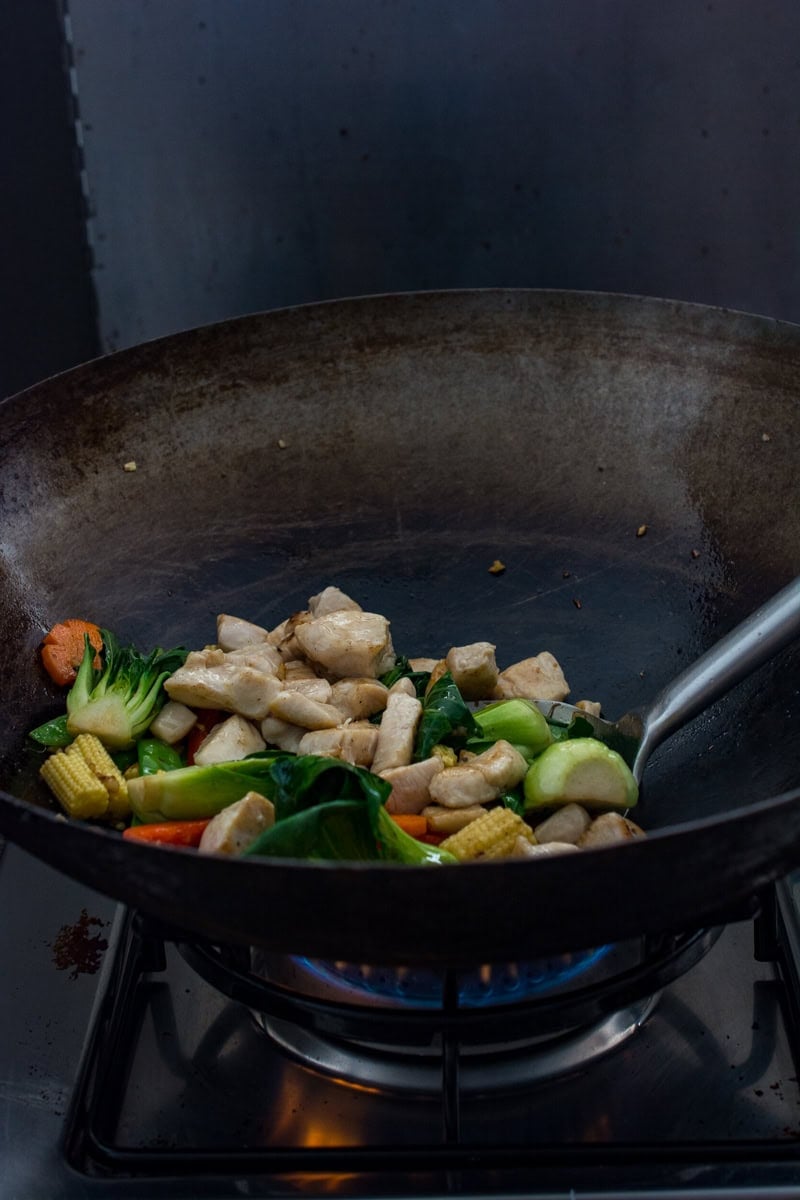 stir frying chicken and vegetables