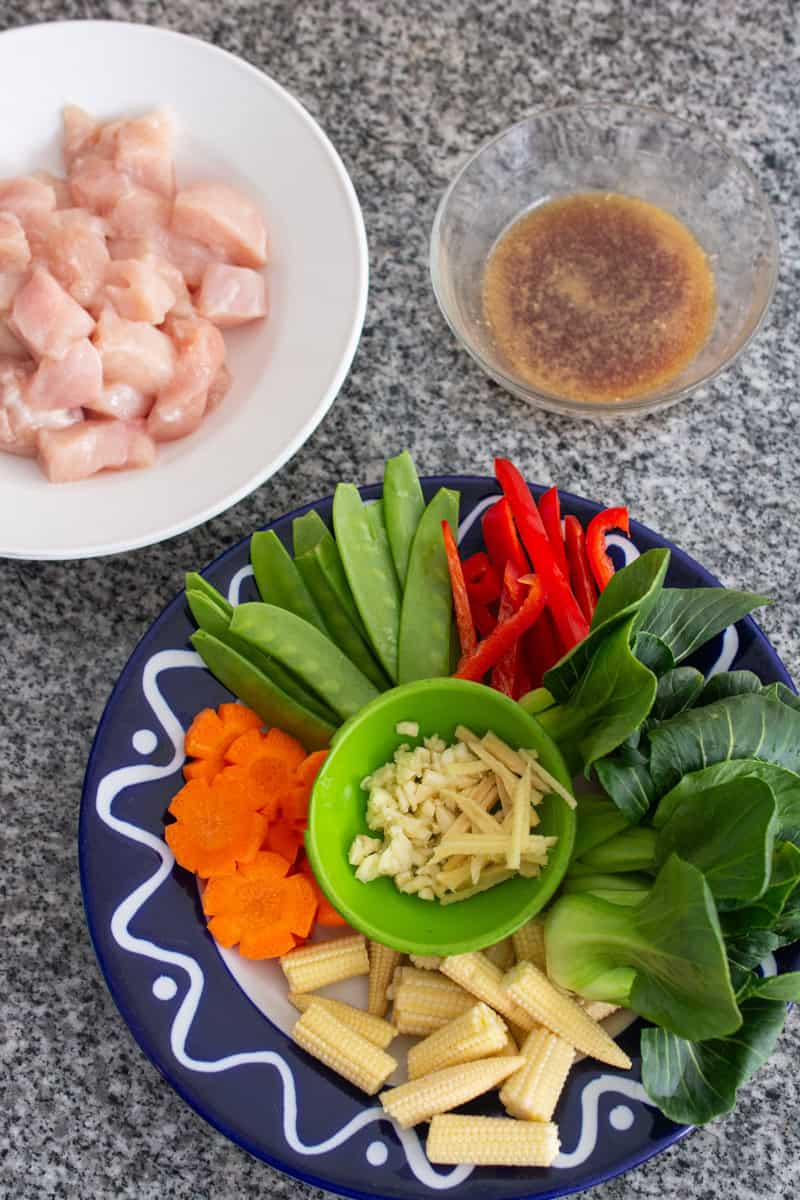 raw chicken, vegetables, and sauce for stir fry