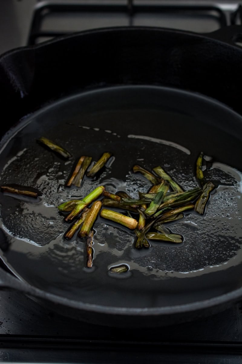 charred scallions in skillet