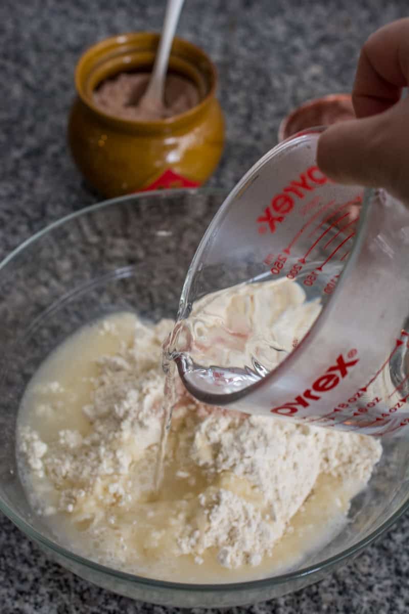 pouring water into flour