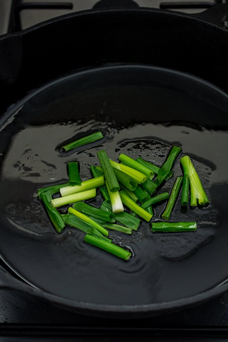 fresh scallions in a skillet