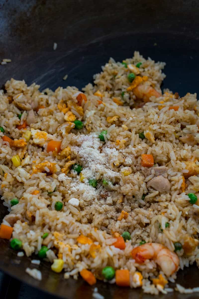 fried rice with seasoning in a wok